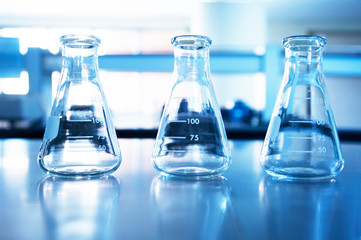 three glass flask of research chemical science laboratory blue education background