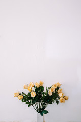 Bouquet of beautiful yellow roses in ceramic vase