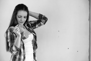 The builder makes repairs in the apartment. Finishing works on plastering and painting of walls. Masters work with paint drill and electricity.