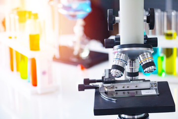 Close up microscope with colorful test tube. They are in laboratory. Scientific,healthcare,...