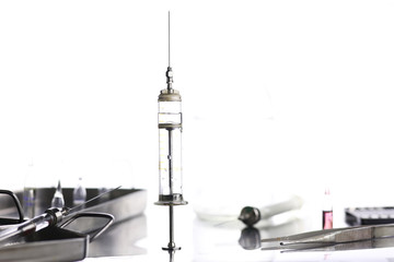 Old metal medical syringe and accessories on the table