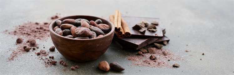 Raw cocoa beans in bowl. Close-up view