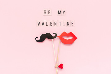 Text Be my Valentine and couple paper mustache, lips props fastened clothespin heart on stick on...