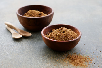 Organic coconut sugar in wooden bowl. A healthy alternative to sugar. Close up view