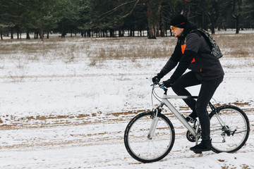 Man on a bike in the winter forest