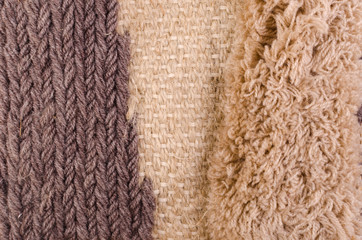 Vertical fragment of tapestry with wool threads. Colorful fabric with fluffy texture in warm...