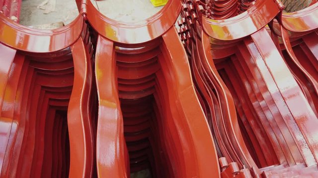 Red casing centralizers stacked on the deck of a drilling rig