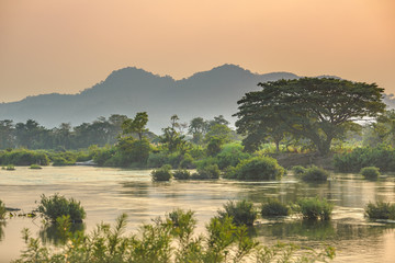 Mekong River 4000 islands Laos, sunrise dramatic sky, mist fog on water, famous travel destination...