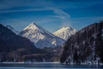 Fototapeta na wymiar Panoramic view of a lake in the European Alps, dark, cloudy background concept