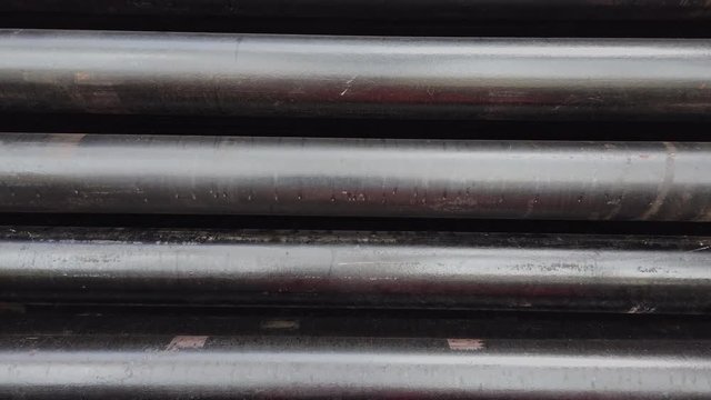 Oil well casing bundles with centralizers installed stacked on the deck of a drilling rig