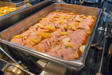 A slice ham with orang sauce in dish