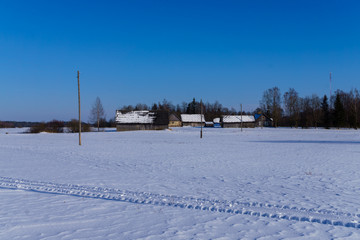 Old houses in winter, frosty morning in Latvia in the village.