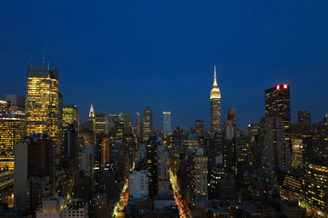 Fototapeta na wymiar Aerial and panorama view of skyscrapers of New York City, Manhattan. Top view of night midtown of Manhattan