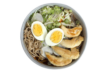Ramen with chicken, eggs, vegetables and noodles on a white background