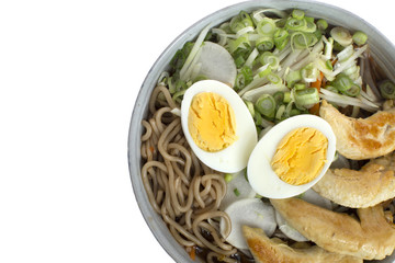 Ramen with chicken, eggs, vegetables and noodles on a white background