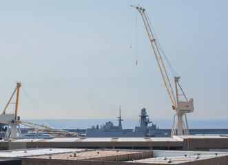 Fototapeta na wymiar Genoa - Italy, an impressive crane during the loading phases in the port