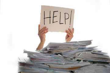 Person under a pile of papers with a hand holding a sign of help. Accounting. 