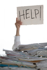 Person under a pile of papers with a hand holding a sign of help. Accounting. 