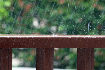 Rain drops on wooden railing