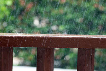 Rain drops on wooden railing
