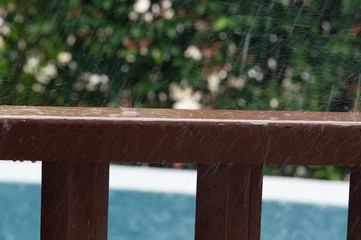 Rain drops on wooden railing
