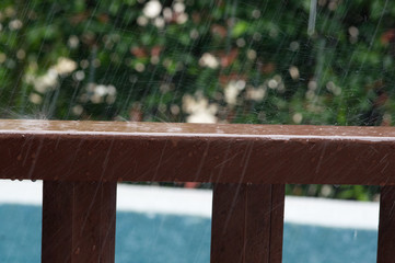 Rain drops on wooden railing