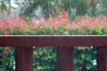 Rain drops on wooden railing
