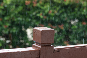 Rain drops on wooden railing