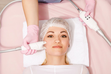 woman receiving wrinkle treatment at beauty salon. Acoustic Wave Therapy for skin rejuvenation