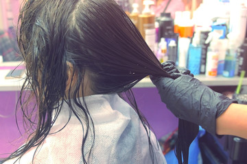 Application of keratin to the hair with a brush. Strengthening the hair with keratin.