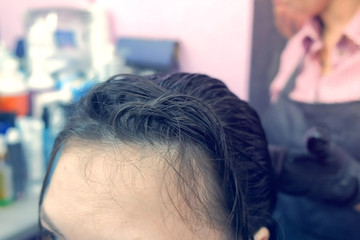 Application of keratin to the hair with a brush. Strengthening the hair with keratin.