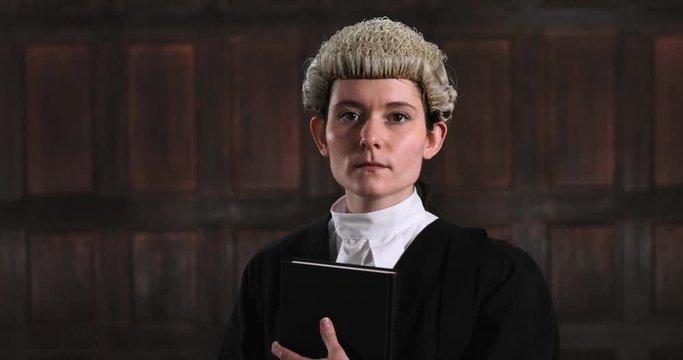 Portrait Of Female Lawyer In Court Reading Law Book