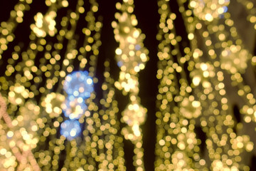 Close-up gold christmas lights blur background. Christmas street lights.