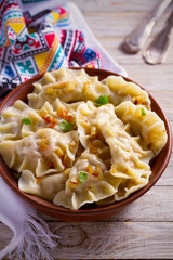 Dumplings, filled with cabbage. Varenyky, vareniki, pierogi, pyrohy - dumplings with filling. vertical