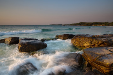 Beautiful sunrise over the beach in Ko Samet, rocks and sea waves, Thailand
