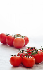 Fresh ripe red cherry tomatoes on a marble background