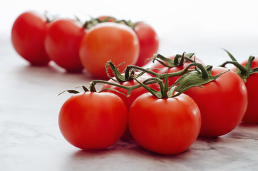 Fresh ripe red cherry tomatoes on a marble background