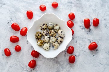 Fresh quail eggs with tomatoes