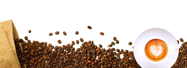 Coffee beans out of the bag and a cup of coffee on a white background
