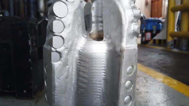 Gimbal Shot of New PDC Bit (Polycrystalline Diamond Compact Bit) on the floor for Oil and Gas Well Drilling
