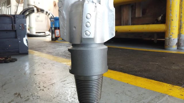 Gimbal Shot of New PDC Bit (Polycrystalline Diamond Compact Bit) on the floor for Oil and Gas Well Drilling
