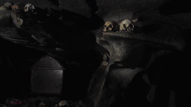 Skull in the candlelight in a cave at a tomb in Tana Toraja, Indonesia, Mai 2018