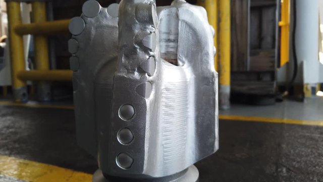 Gimbal Shot of New PDC Bit (Polycrystalline Diamond Compact Bit) on the floor for Oil and Gas Well Drilling