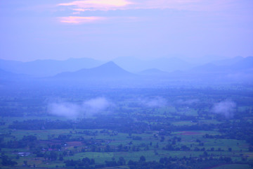 Fototapeta premium Beautiful sunrise and the mist on highland with mountain in Thailand