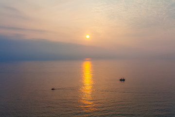 Obraz premium Two boats in the sea at sunset time