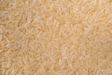 Yellow rice grains. Top view. Food Background. A scattering of grains. Healthy food. Natural food.