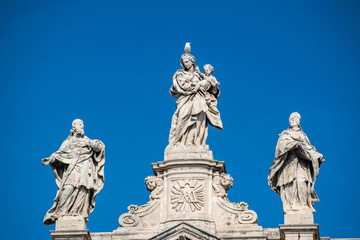 Fototapeta na wymiar Statues of saints at the top of the facade of Basilica of Saint Mary Major (Basilica di Santa Maria Maggiore, 1743), Rome, Italy