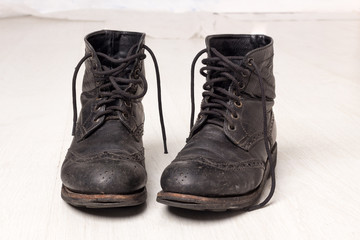 Pair of old leather black hipster boots