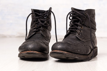Pair of old leather black hipster boots