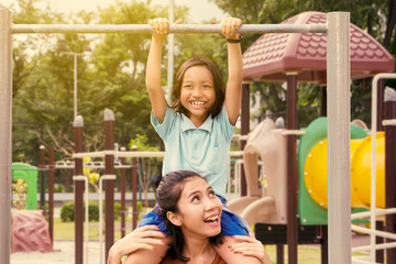 Fototapeta premium Mother and daughter playing in the playground